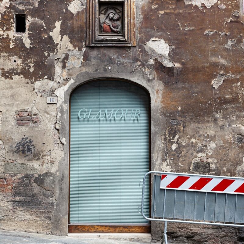 an old building with a blue door and shutters