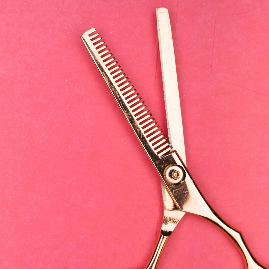 silver scissors on pink textile